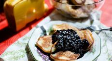 Lemon fritters with ricotta and blackberry sauce